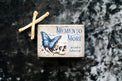 Memento Mori tarot card deck with butterfly and skull design, bones on dark textured background
