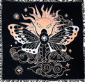 Decorative throw blanket with celestial design featuring a butterfly and sun on a black background.