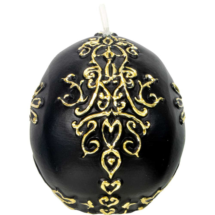 Black egg-shaped candle with ornate gold filigree design, metaphysical decor