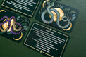 Tarot cards with illustrated snakes, moon, and text on a green background, spiritual decor.