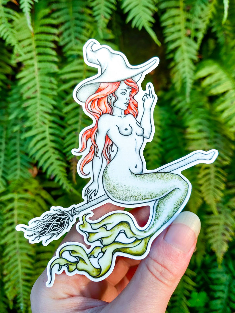 Mermaid Sand Witch vinyl sticker, a red haired mermaid in a witch hat riding a broom