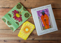 Radiant Tarot deck with illustrated cards, guidebook, and box on a wooden table.