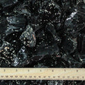 Snowflake obsidian crystal chunks with a ruler for scale