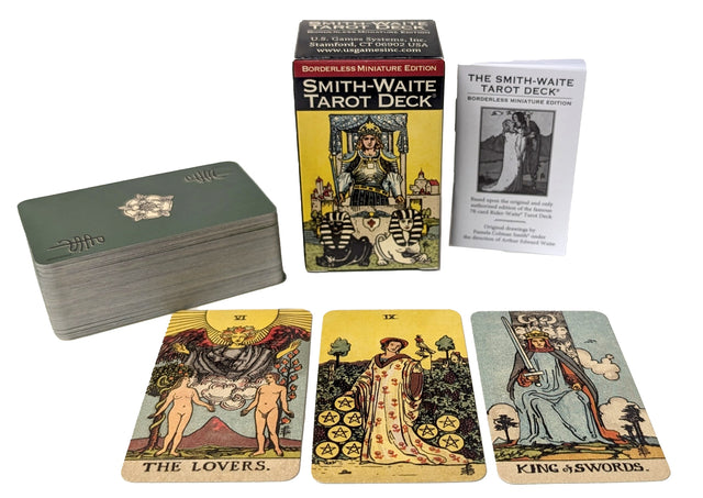 Smith-Waite Tarot Deck with The Lovers, Nine of Pentacles, and King of Swords cards displayed
