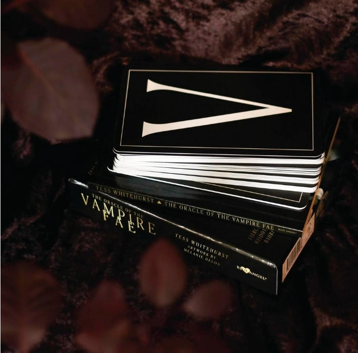 Oracle of the Vampire Fae tarot deck on a dark velvet surface, mystical and metaphysical vibe