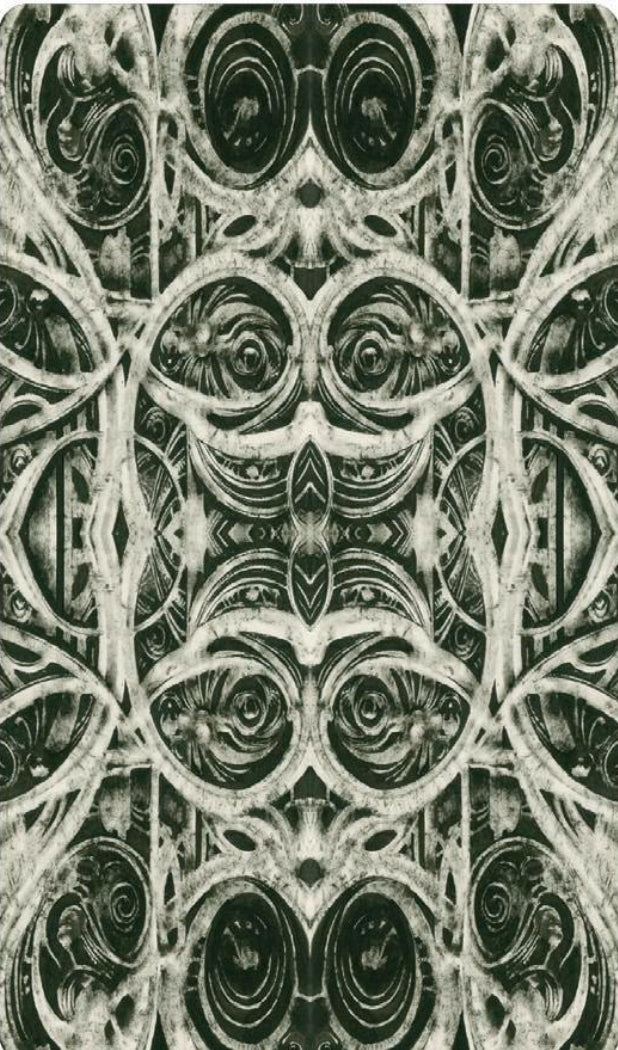 Intricate black and white tarot card back with ornate symmetrical pattern design